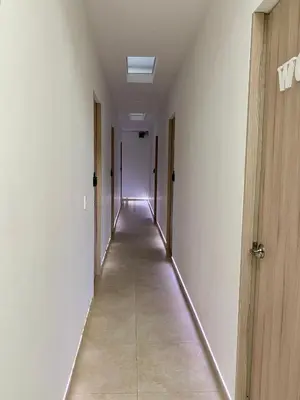 an empty hallway with a long corridor with doors at Guakmaya hostel in Cartagena de Indias