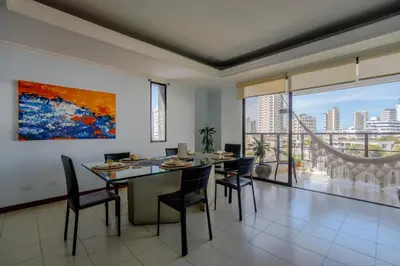 a dining room with a table and chairs and a large window at Habitación doble baño privado cerca al mar y bahia in Cartagena de Indias