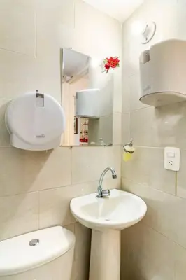 a white bathroom with a sink and a toilet at Apartamento en Centro Histórico De Cartagena in Cartagena de Indias
