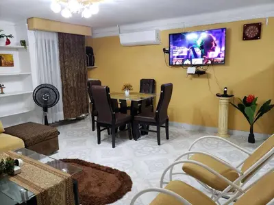 a living room with a table and a tv on the wall at Apartamento en Centro Histórico De Cartagena in Cartagena de Indias