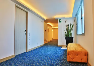 a hallway with an orange ottoman in a hotel room at Washington Plaza in Barranquilla