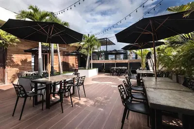 an outdoor patio with tables and chairs and umbrellas at Hotel Cartagena DC in Cartagena de Indias