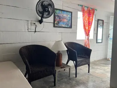 two chairs and a table with a lamp in a room at AcapulcoBeach in Playa Blanca