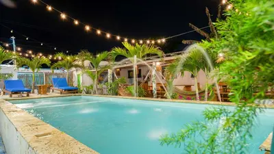 a swimming pool at night with chairs and lights at CASA PLAYA JAMES in La Boquilla