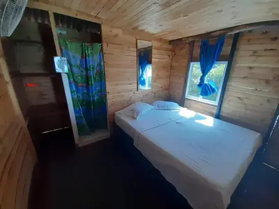 a bedroom with a white bed and two windows at Hugos Place Baru in Playa Blanca