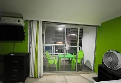 a room with a green room with a table and chairs at El Conquistador in Cartagena de Indias