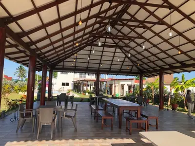 a large pavilion with tables and chairs and people at Casa Bita Morales CASA 101 in Las Canoas