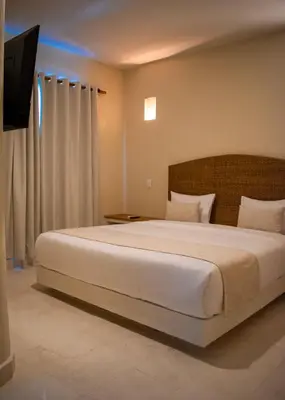 a bedroom with a large bed in a room at Casa Noa Colonial Rooms in Cartagena de Indias
