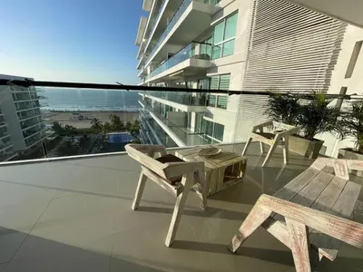 a balcony with a table and chairs on a building at Condominio frente al mar con acceso directo a la playa Morros Ultra in Cartagena de Indias