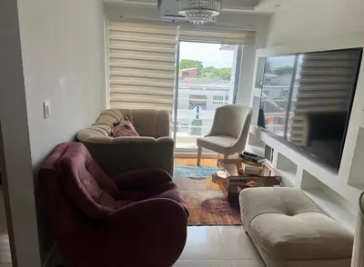 a living room with two chairs and a flat screen tv at APARTAMENTO NUEVo in Cartagena de Indias