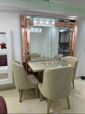 a dining room with a table and chairs and a mirror at APARTAMENTO NUEVo in Cartagena de Indias