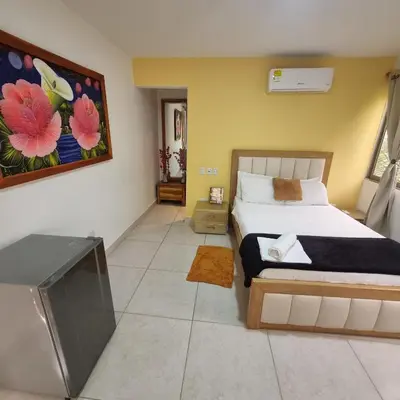 a bedroom with a bed and a flat screen tv at Dreimar Hotel Boutique in Cartagena de Indias