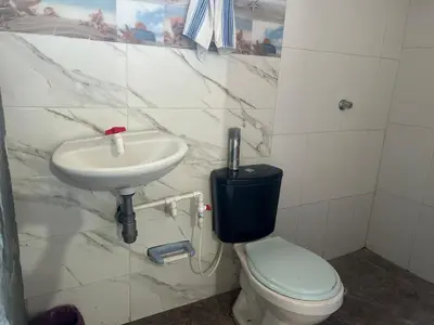 a white bathroom with a sink and a toilet at Punta Arena EcoHostal & EcoFit - Your Eco-Friendly Oasis 01 in Playa Punta Arena