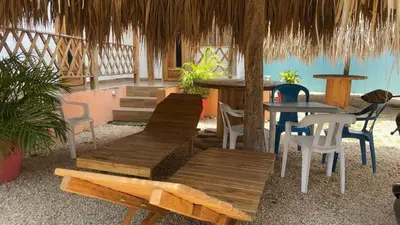 a restaurant with wooden benches and tables and chairs at Cabaña El Cangrejo Azul - Blue Crab House in San Onofre