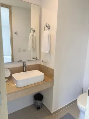 a bathroom with a sink and a mirror at Acogedor apartamento en exclusivo barrio de Barranquilla BUENAVISTA - SUNSET VIEW in Barranquilla