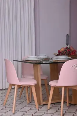 a dining table with pink chairs and plates on it at Apartahotel Edificio Baquero x10 Apto 403 in Barranquilla