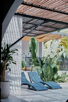 a patio with two lounge chairs and plants at Gaia Casa de Mar in El Bobo