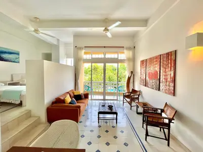 a living room with a couch and a table at by Calamari Homes - Parque Centenario 202 walled city in Cartagena de Indias