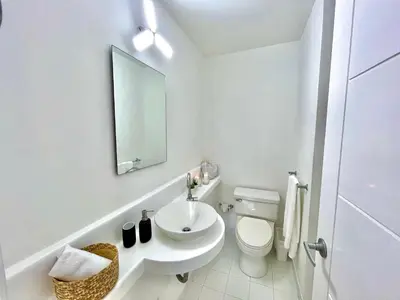 a white bathroom with a sink and a toilet at by Calamari Homes - Parque Centenario 202 walled city in Cartagena de Indias