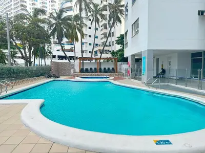 a large swimming pool in the middle of a building at Prime Location: Fully Equipped Loft in El Laguito in Cartagena de Indias