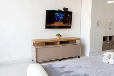 a living room with a tv on top of a cabinet at Prime Location: Fully Equipped Loft in El Laguito in Cartagena de Indias