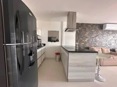 a kitchen with a stainless steel refrigerator in a room at Prime Location: Fully Equipped Loft in El Laguito in Cartagena de Indias