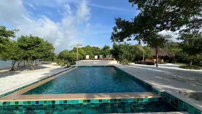 a swimming pool in the middle of a resort at ACASI Rustic Beach in Baru