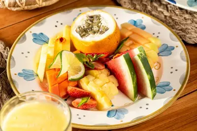 a plate of fruit and vegetables on a table at ACASI Rustic Beach in Baru