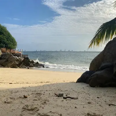 a sandy beach with a view of the ocean at Punta Arena EcoHostal & EcoFit - Your Eco-Conscious Oasis in Cartagena de Indias