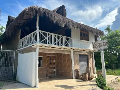 an old building with a straw roof at Punta Arena EcoHostal & EcoFit 01 in Playa Punta Arena