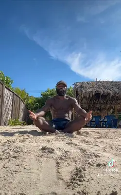 a man sitting on the beach doing meditation at Punta Arena EcoHostal & EcoFit 01 in Playa Punta Arena