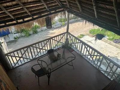 an overhead view of a table and chair on a balcony at Punta Arena EcoHostal & EcoFit 01 in Playa Punta Arena