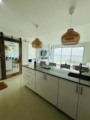 a kitchen with white cabinets and a view of the ocean at Cartagena in Cartagena de Indias