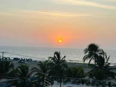 a sunset over a beach with palm trees and the ocean at Cartagena in Cartagena de Indias