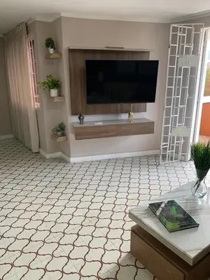 a living room with a flat screen tv on a wall at Apartahotel Edificio Baquero x5 Apto 401 in Barranquilla