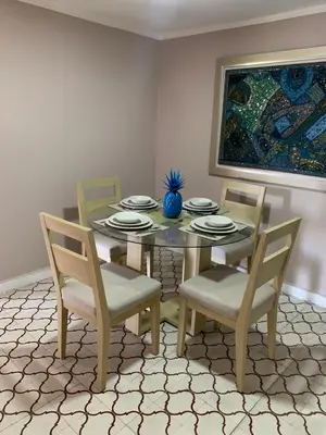 a dining room with a table and chairs and a painting at Apartahotel Edificio Baquero x5 Apto 401 in Barranquilla