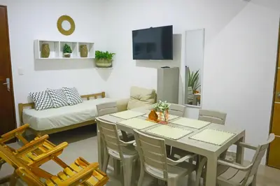 a living room with a table and chairs and a couch at Apartamento Arenita de mar in Coveñas