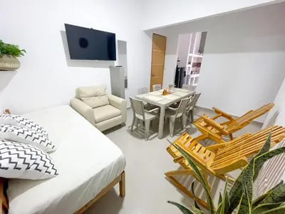 a living room with a couch and a table and chairs at Apartamento Arenita de mar in Coveñas
