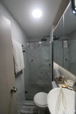 a bathroom with a shower and a toilet and a sink at Nice Apartment close to Historic City and beach in Cartagena de Indias