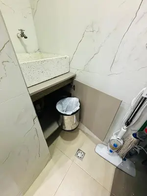 a small bathroom with a sink and a trash can at Nice Apartment close to Historic City and beach in Cartagena de Indias