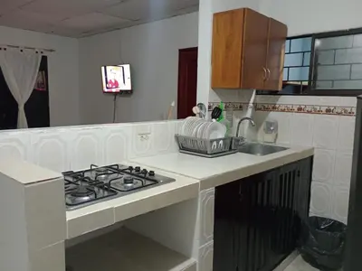 a kitchen with a stove and a sink at Apartamentos Poseidon in Coveñas