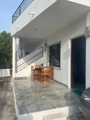 a patio with a table and chairs on a house at Apartamentos Poseidon in Coveñas