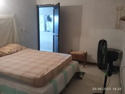 a bedroom with a bed and a blue door at Hostal Sol in Cartagena de Indias
