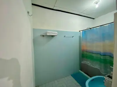 a bathroom with a shower with a rainbow shower curtain at Habitación Multiple cerca de aeropuerto in Cartagena de Indias