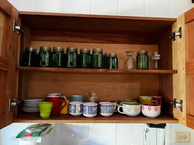 a cabinet filled with lots of cups and plates at Casa finca Santiago Tolú in Altamira