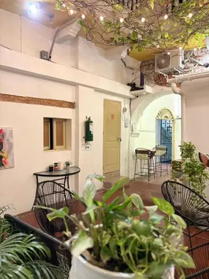 a room with chairs and a table with plants at Casa Zaguan in Cartagena de Indias