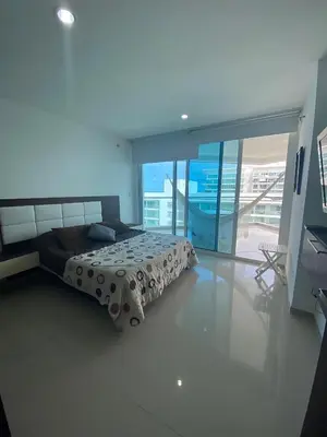 a bedroom with a bed and a large window at Apartamento playa Morros, La boquilla, Cartagena de indias in Cartagena de Indias