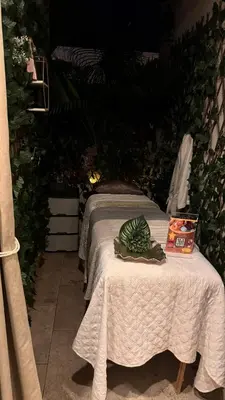 a bed with a table with a box on it at Dominique in Cartagena de Indias
