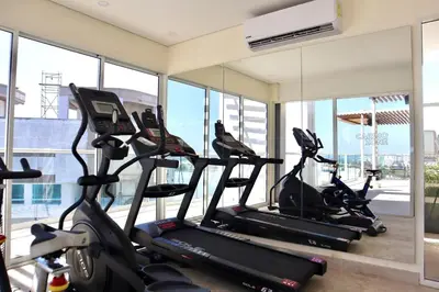 a gym with three treadmills and elliptical machines at Dominique in Cartagena de Indias