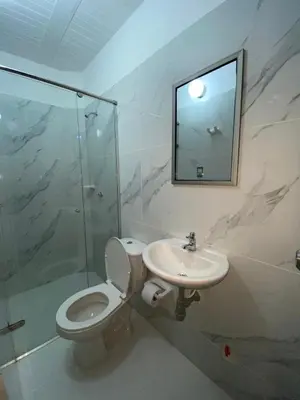 a bathroom with a toilet and a sink and a mirror at Hotel Rancho Grande in Barranquilla
